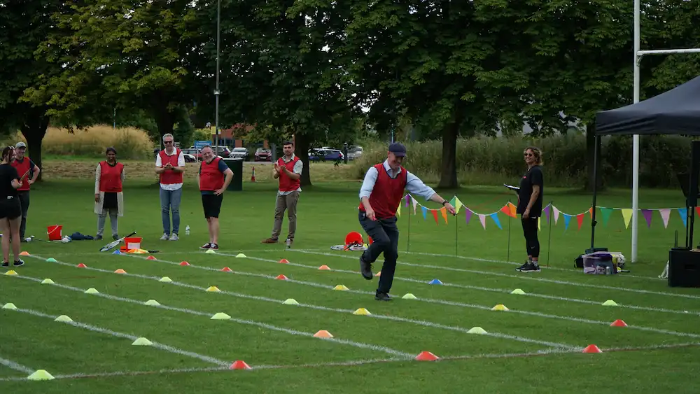 Outdoor Office Olympics people in skipping race