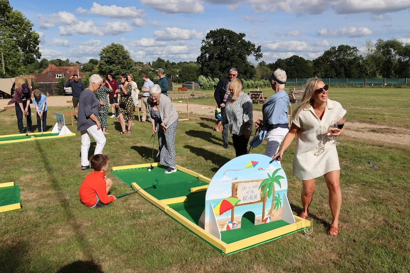 group playing mini golf at event